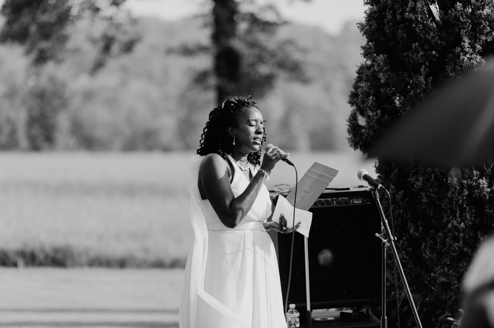 A woman sings into a microphone at the wedding.

Luxury Texas Wedding Photographer. Timeless Wedding Photography. Wedding in Texas. Destination Wedding Photographer.