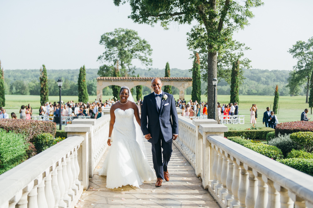 Bride and groom walk along a fenced in path away from the ceremony. They are smiling and holding hands.

Luxury Texas Wedding Photographer. Timeless Wedding Photography. Wedding in Texas. Destination Wedding Photographer.