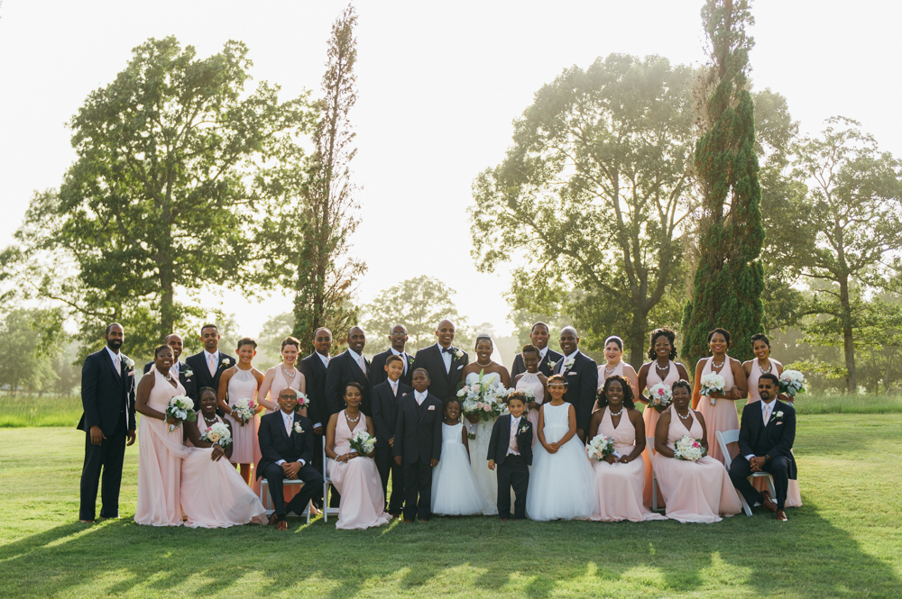 Portrait of the bride, groom, and the entire wedding party and flower girls standing and sitting in a grassy field.

Luxury Texas Wedding Photographer. Timeless Wedding Photography. Wedding in Texas. Destination Wedding Photographer.