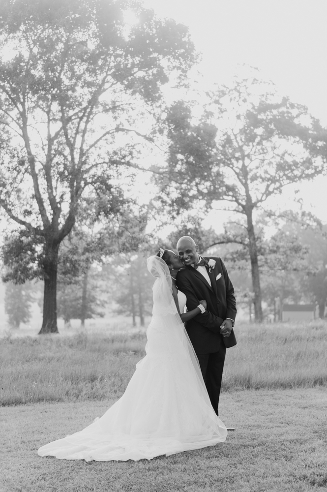 Bride stands behind the groom with her hand on his arm and kisses his cheek as he smiles.

Luxury Texas Wedding Photographer. Timeless Wedding Photography. Wedding in Texas. Destination Wedding Photographer.
