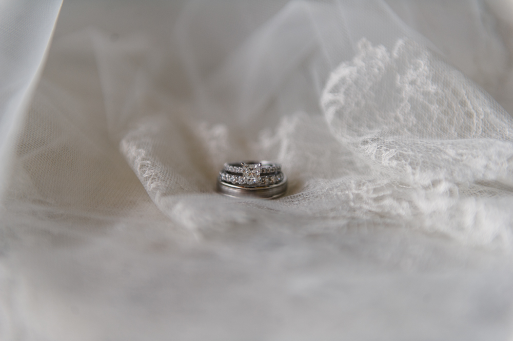 Close-up of the wedding rings and engagement ring sitting in a stack on the bride's veil.

Luxury Texas Wedding Photographer. Timeless Wedding Photography. Wedding in Texas. Destination Wedding Photographer.
