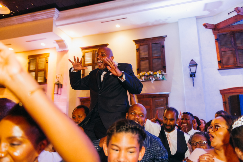 Groom is raised up in the air on the shoulders of two men. Wedding guests are dancing all around them.

Luxury Texas Wedding Photographer. Timeless Wedding Photography. Wedding in Texas. Destination Wedding Photographer.