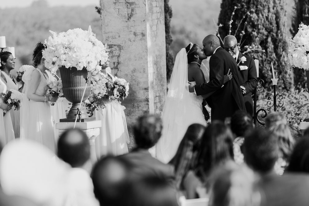 Bride and groom kiss at the altar as wedding guests are seen seated in the foreground.

Luxury Texas Wedding Photographer. Timeless Wedding Photography. Wedding in Texas. Destination Wedding Photographer.