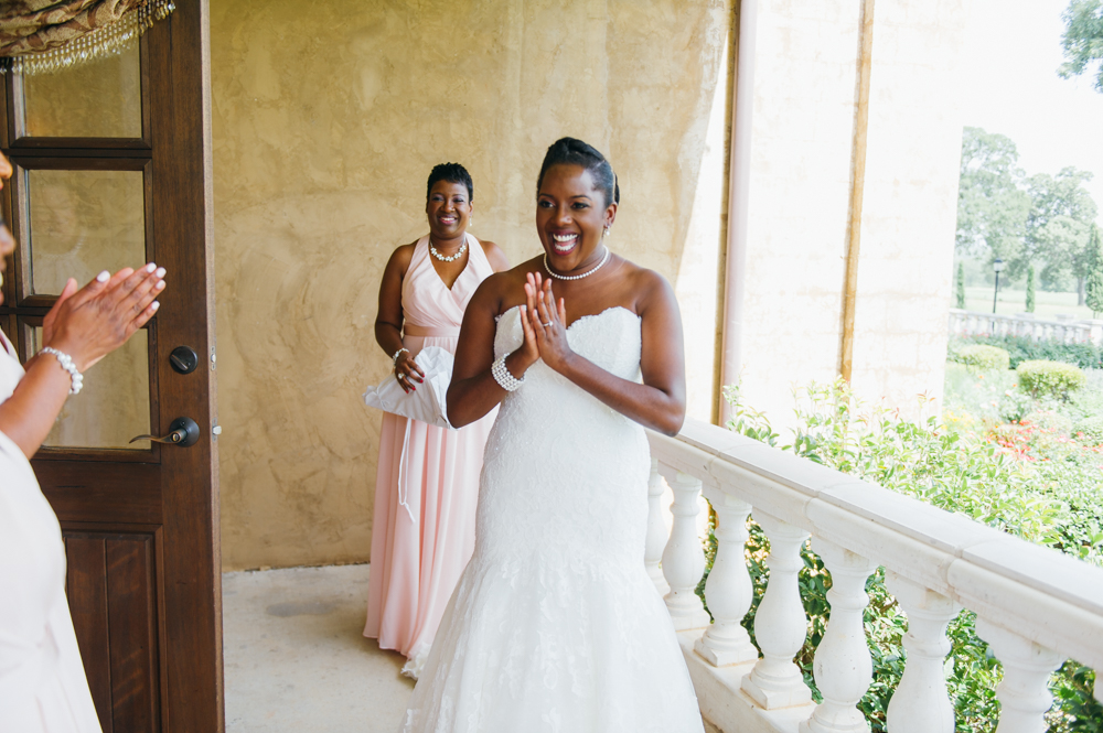 Bride stands on a terrace in her wedding dress with a big smile on her face looking at loved ones around her.

Luxury Texas Wedding Photographer. Timeless Wedding Photography. Wedding in Texas. Destination Wedding Photographer.