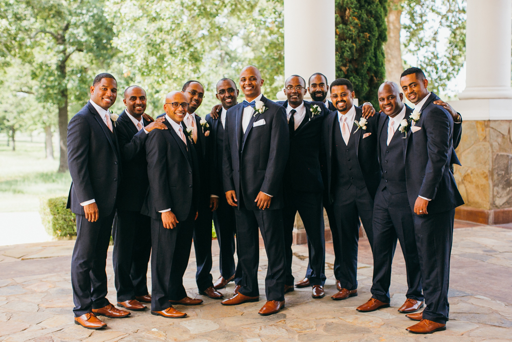 Groom stands outside surrounded by his groomsmen— they are all smiling at the camera.

Luxury Texas Wedding Photographer. Timeless Wedding Photography. Wedding in Texas. Destination Wedding Photographer.
