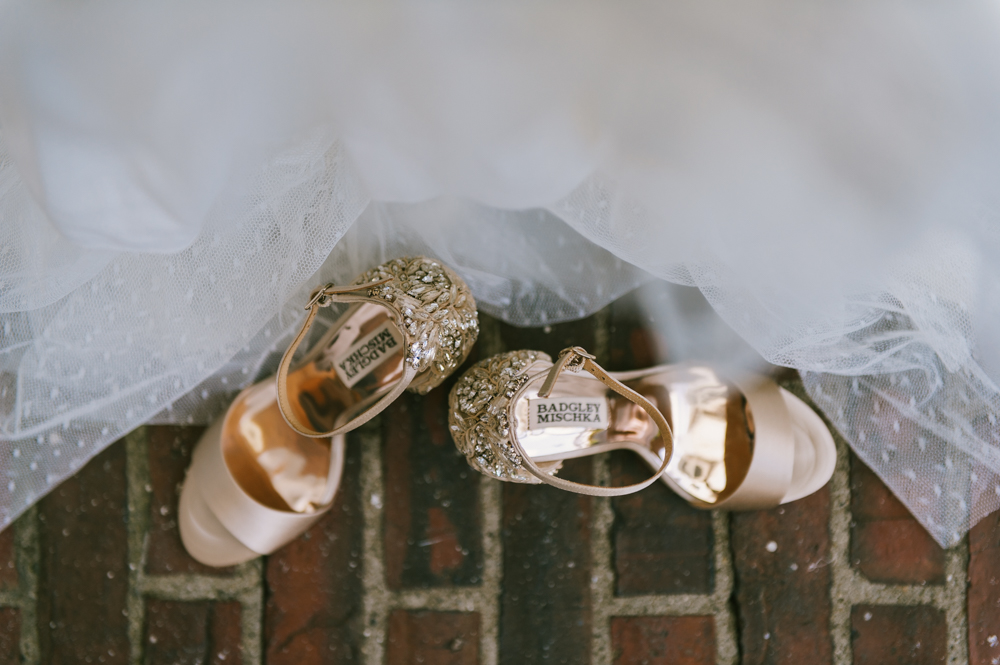 Sparkly golden high heels are sitting on a brick path with a veil beside them. 

Highlands Country Club Wedding. Upstate NY Wedding Photographer. Luxury Wedding Photographer. Upstate New York Wedding Photography.