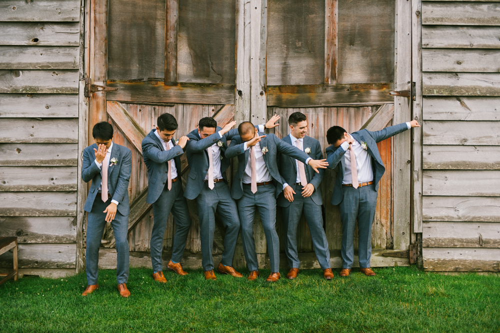 Groom and his groomsmen are lined up outside the barn and are doing "the dab" dance move.

Highlands Country Club Wedding. Upstate NY Wedding Photographer. Luxury Wedding Photographer. Upstate New York Wedding Photography.