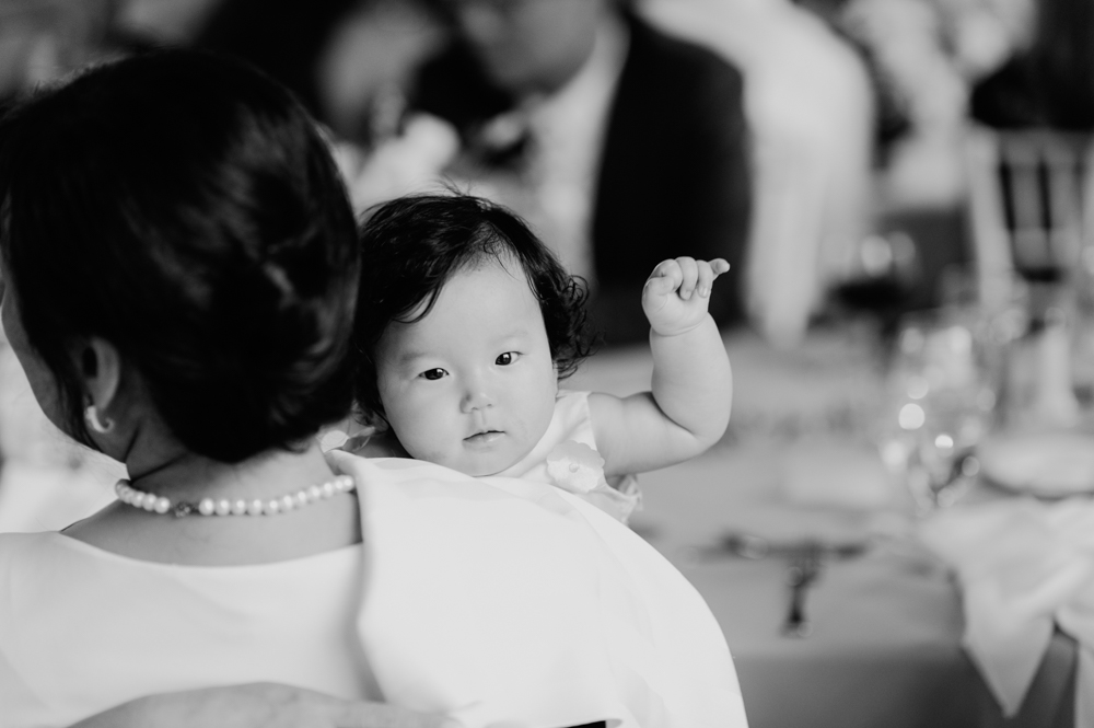 A woman is seated facing away from the camera with a baby held in her arms looking over her shoulder at the camera.

Highlands Country Club Wedding. Upstate NY Wedding Photographer. Luxury Wedding Photographer. Upstate New York Wedding Photography.