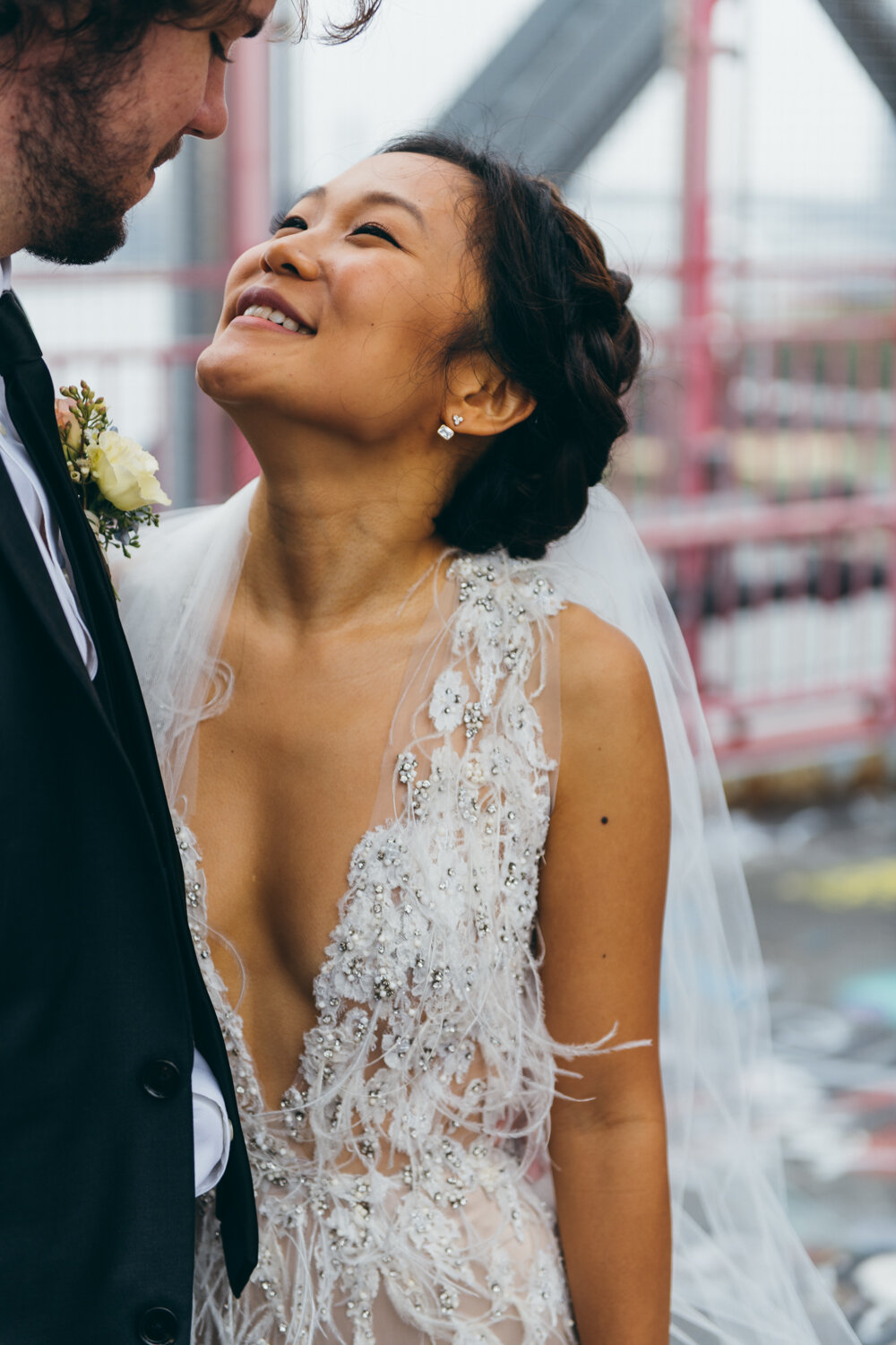 Bride looks up at the groom with a big smile on her face as he smiles down at her. The feathers on her white dress are blowing in the wind.

Central Park Wedding Photography. Williamsburg Bridge Bridal Portraits. Luxury NYC Wedding Photographer. Manhattan Micro Wedding.