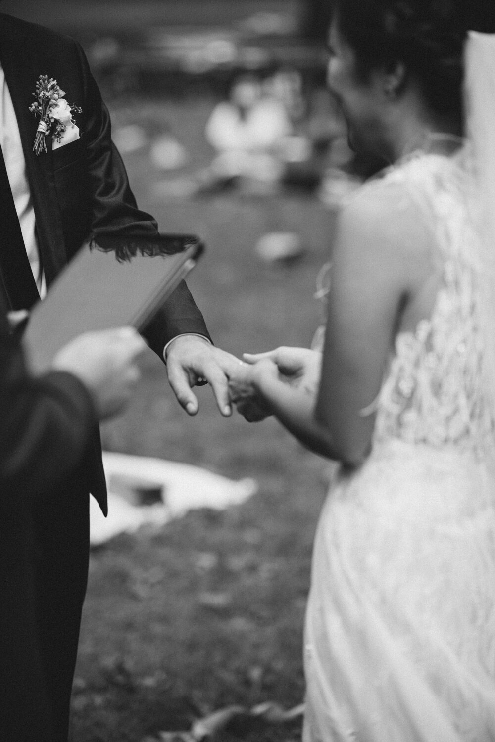 Bride holds the groom's hand and puts a wedding ring on his finger.

Central Park Wedding Photography. Williamsburg Bridge Bridal Portraits. Luxury NYC Wedding Photographer. Manhattan Micro Wedding.