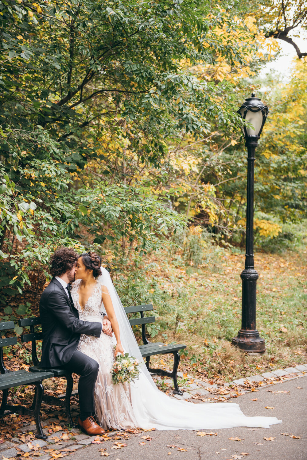 Bride and groom sit on a bench in Central Park beside a lamp pst and kiss.

Central Park Wedding Photography. Williamsburg Bridge Bridal Portraits. Luxury NYC Wedding Photographer. Manhattan Micro Wedding.