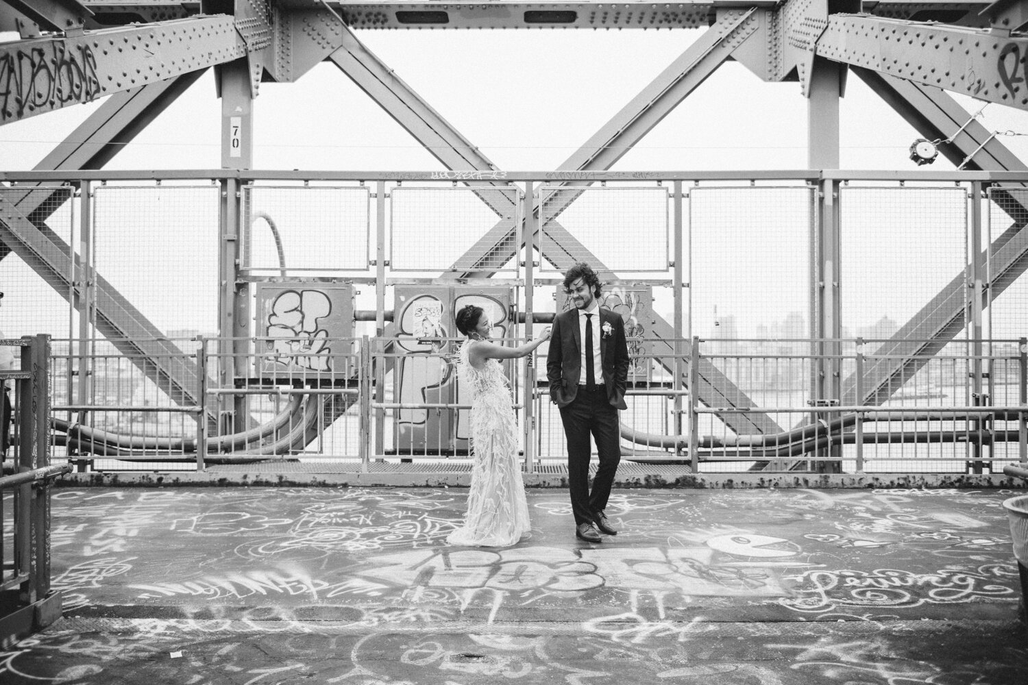 Bride taps groom on the shoulder as they both stand on the Williamsburg Bridge. 

Central Park Wedding Photography. Williamsburg Bridge Bridal Portraits. Luxury NYC Wedding Photographer. Manhattan Micro Wedding.