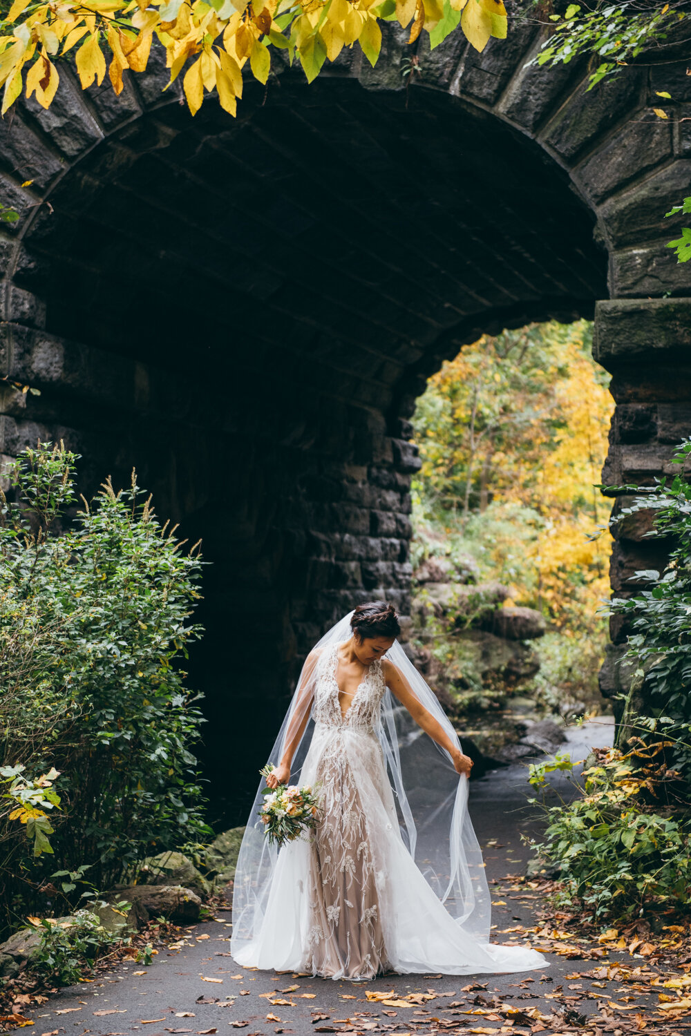 Bride stands beneath a stone archway in Central Park. She is holding her veil and looking down.

Central Park Wedding Photography. Williamsburg Bridge Bridal Portraits. Luxury NYC Wedding Photographer. Manhattan Micro Wedding.