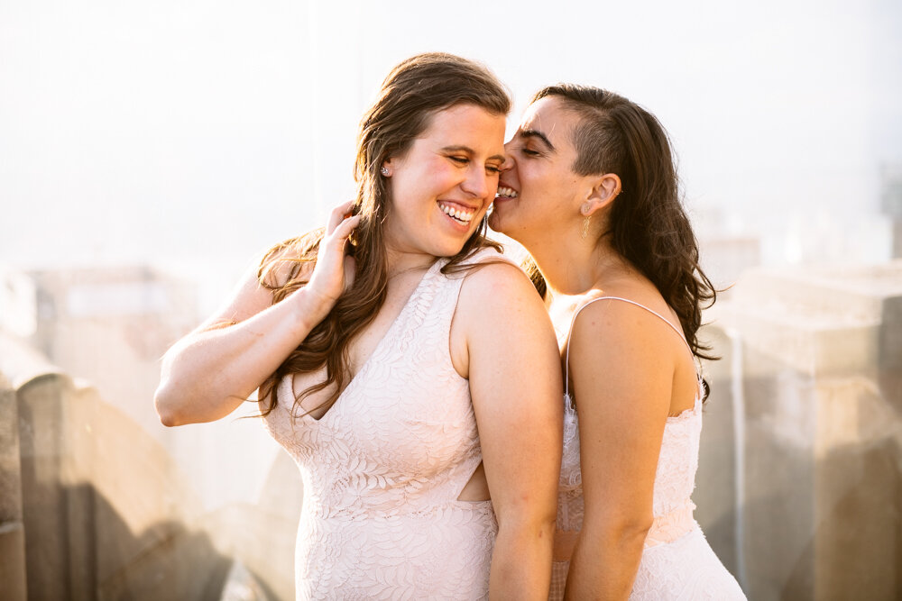 One bride stands behind the other with her nose nuzzled in the side of her face. They are both smiling.

Luxury NYC Wedding Photography. Queer Wedding Photography. Inclusive Wedding Photographer. LGBTQ+ Manhattan Wedding.