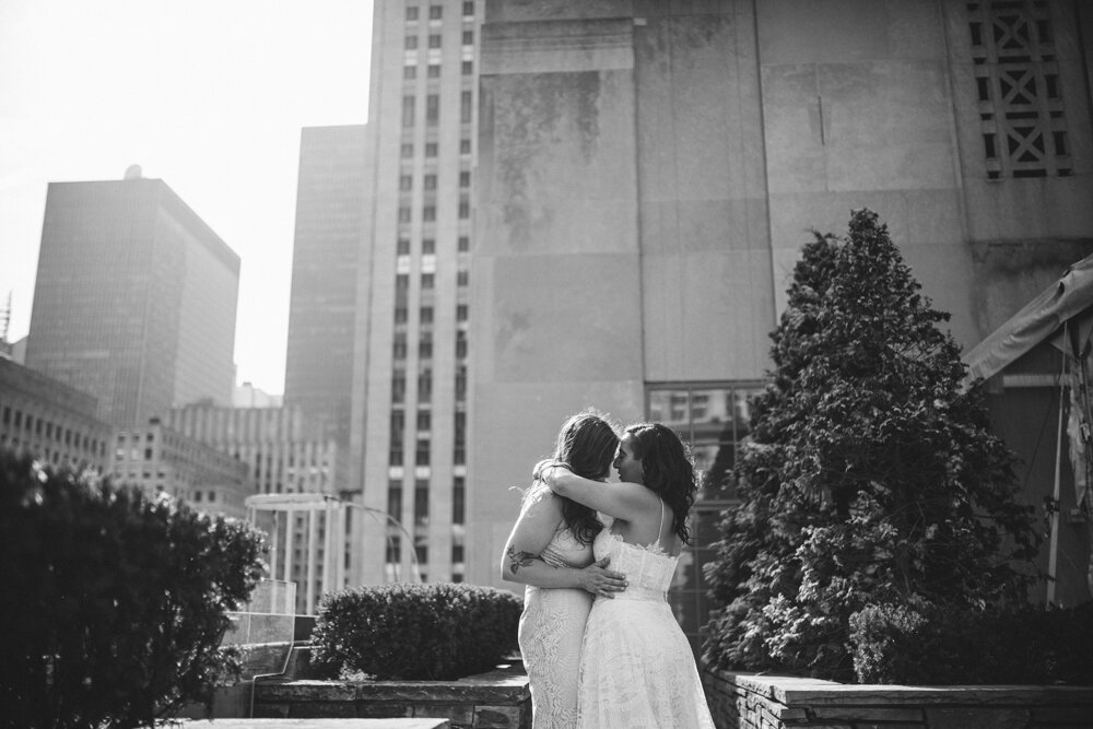 Two brides stand facing each other with arms around each other and noses touching. They are standing at the Top of the Rock and Manhattan buildings are visible behind them.

Luxury NYC Wedding Photography. Queer Wedding Photography. Inclusive Wedding Photographer. LGBTQ+ Manhattan Wedding.