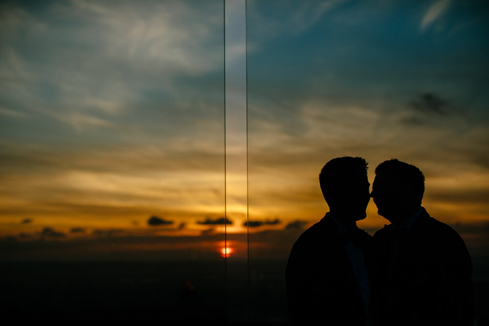 The silhouette of two grooms is seen against the sunset view from the Top of the Rock.

Luxury NYC Wedding Photography. Queer Wedding Photography. Inclusive Wedding Photographer. LGBTQ+ Manhattan Wedding.