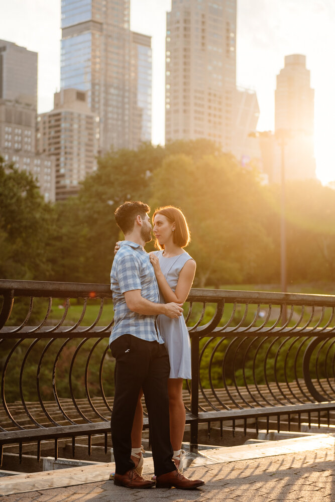 Man and woman stands with their arms around each other and looking into each other's eyes with Central Park and the Manhattan skyline behind them.

Central Park Engagement Portraits. Manhattan Engagement Photography. NYC Engagement Photographer.