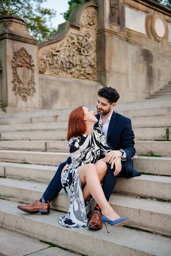 Man and woman sit on the steps in Central Park and look into each other's eyes with smiles on their faces.

Central Park Engagement Portraits. Manhattan Engagement Photography. NYC Engagement Photographer.