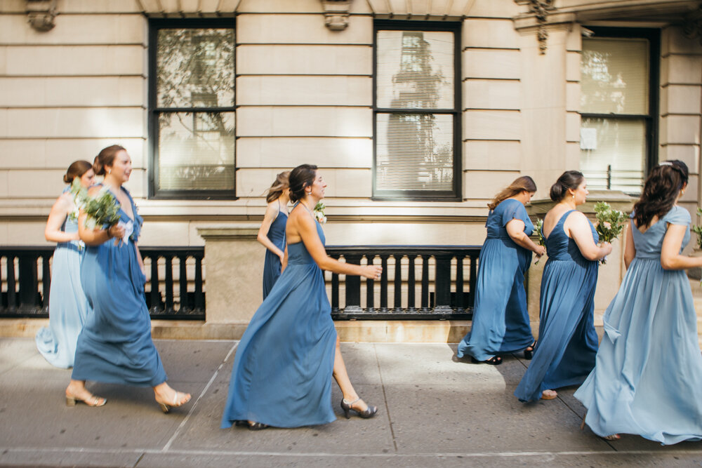 Bridesmaids walk down the Manhattan sidewalk wearing blue dresses and holding bouquets.

Luxury Local Wedding NYC. Wedding in Manhattan. New York City Wedding Photographer. Manhattan Luxury Wedding Photography. Museum of the City of New York Weddings.