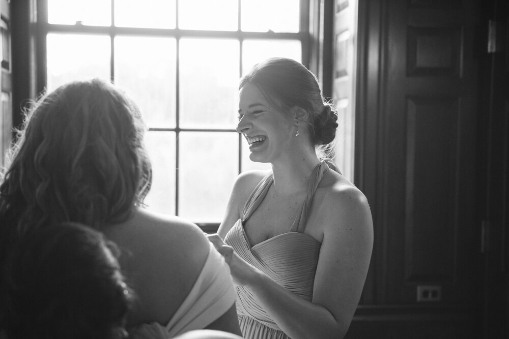 Bride is photographed from behind as a bridesmaid looks on with a big smile.

Luxury Local Wedding NYC. Wedding in Manhattan. New York City Wedding Photographer. Manhattan Luxury Wedding Photography. Museum of the City of New York Weddings.
