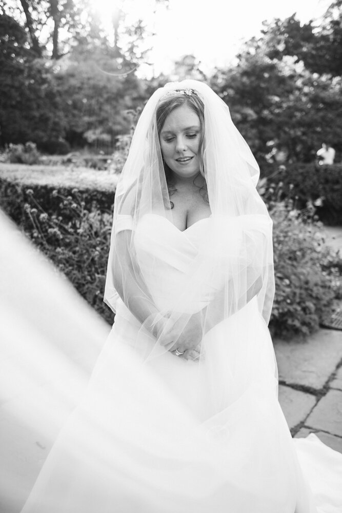 Bride stands outside in a garden with her hands held in front of her and looking down with a smile. Her veil covers the lower left quadrant of the frame.

Luxury Local Wedding NYC. Wedding in Manhattan. New York City Wedding Photographer. Manhattan Luxury Wedding Photography. Museum of the City of New York Weddings.