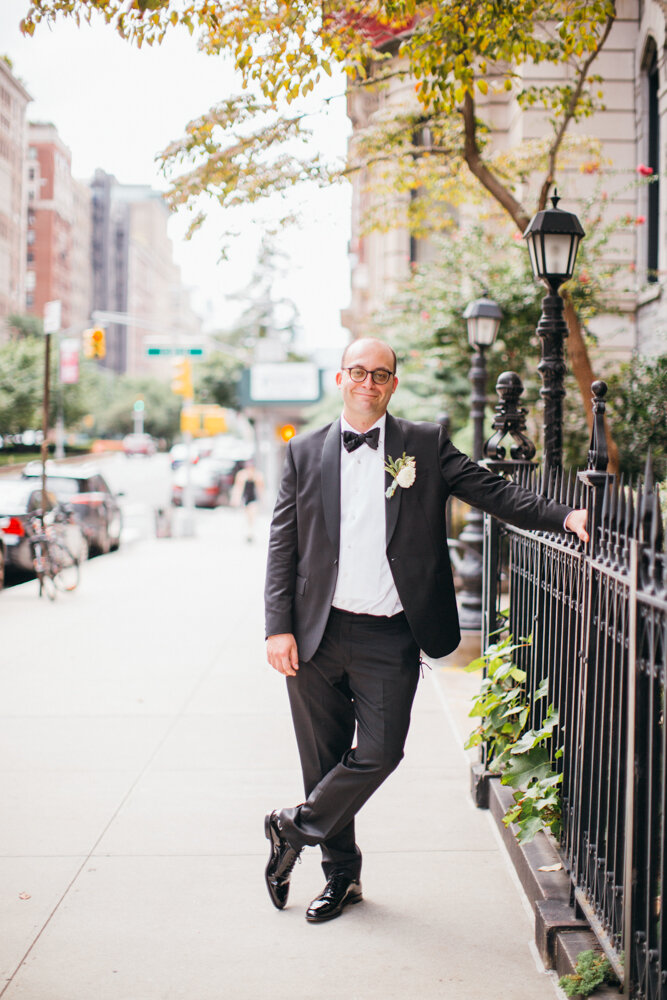 Groom stands outside on a Manhattan sidewalk wearing his tuxedo. He is leaning one arm on a fence and smiling at the camera.

Luxury Local Wedding NYC. Wedding in Manhattan. New York City Wedding Photographer. Manhattan Luxury Wedding Photography. Museum of the City of New York Weddings.