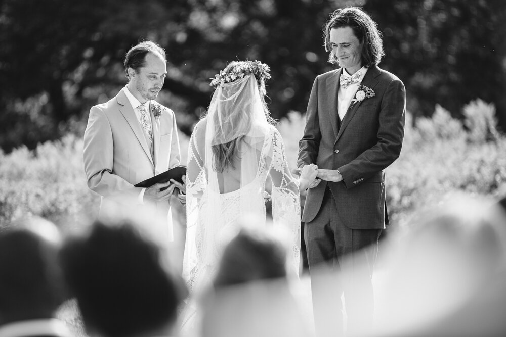 The bride and groom stand facing each other and holding hands in front of the officiant.

Upstate New York Wedding Photographer. Upstate NY Wedding Photography. Luxury Local Wedding Upstate NY.