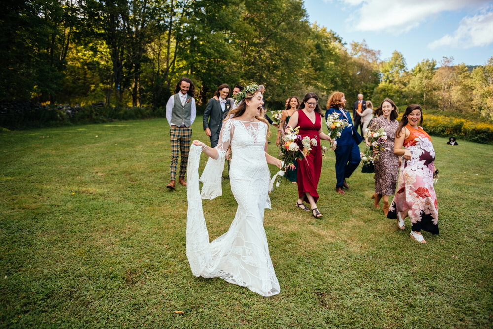 Bride and wedding guests walk down the grassy hill with big smiles and laughs.

Upstate New York Wedding Photographer. Upstate NY Wedding Photography. Luxury Local Wedding Upstate NY.