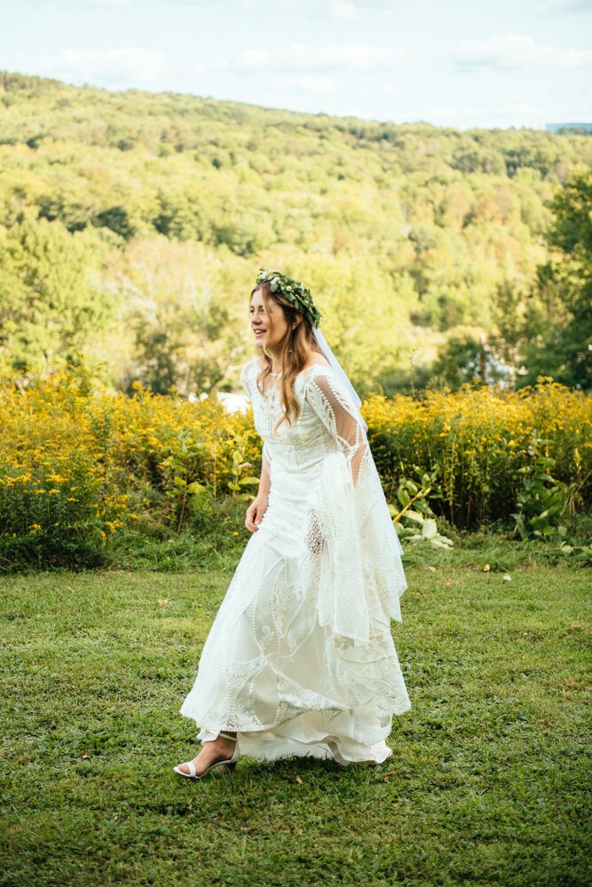 Bride walks through a grassy field in a white wedding dress and flower crown.

Upstate New York Wedding Photographer. Upstate NY Wedding Photography. Luxury Local Wedding Upstate NY.