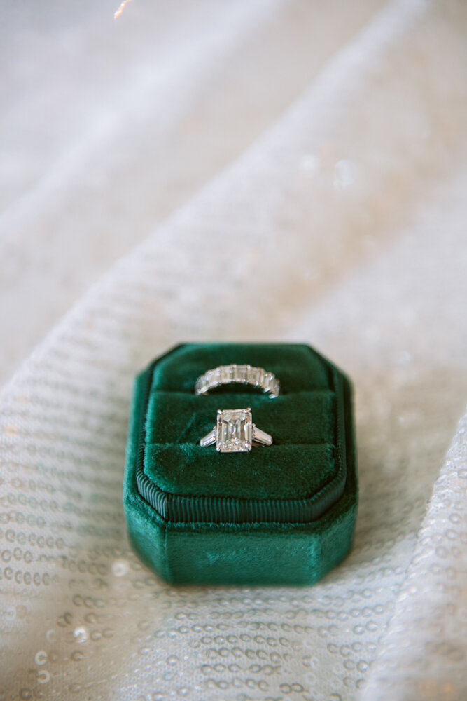 Close-up image of wedding/engagement rings in a green velvet box.

University Club Wedding Photographer. Manhattan Luxury Wedding Photographer. Manhattan Bride and Groom Portraits. Luxury Local Wedding NYC. 