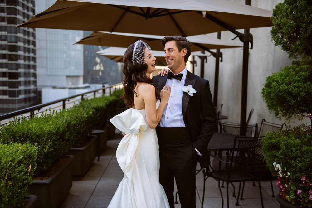 Bride has her arms around the groom as they look at each other with big smiles.

University Club Wedding Photographer. Manhattan Luxury Wedding Photographer. Manhattan Bridal Portraits. Luxury Local Wedding NYC. 