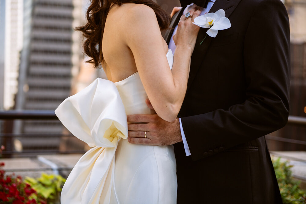 Close-up image of the torsos of the bride and groom. His hands are on her waist and her hands are on his chest.

University Club Wedding Photographer. Manhattan Luxury Wedding Photographer. Manhattan Bridal Portraits. Luxury Local Wedding NYC. 
