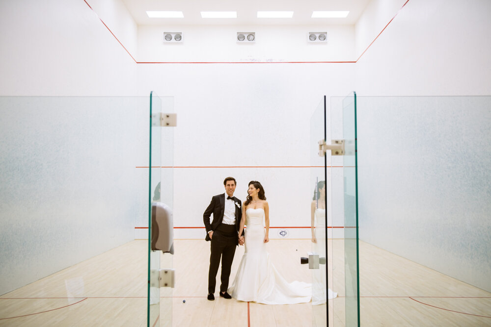 Bride and groom stand in an empty racquetball court. They are photographed through the doorway.

University Club Wedding Photographer. Manhattan Luxury Wedding Photographer. Manhattan Bridal Portraits. Luxury Local Wedding NYC. 