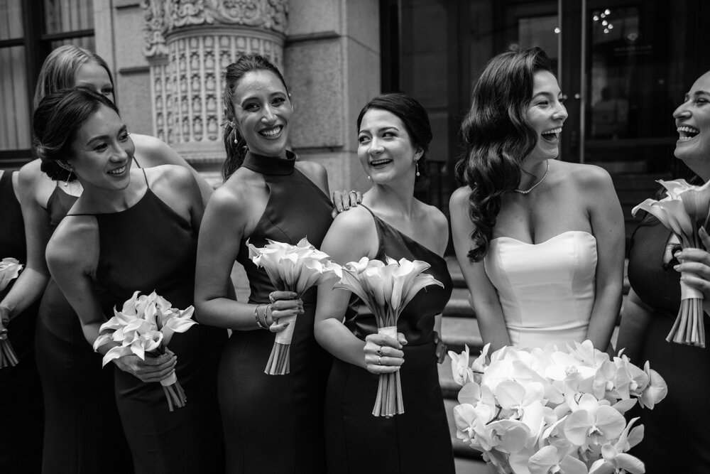 Bride and her bridesmaids are all smiling a one another outside the University Club in New York City.

University Club Wedding Photographer. Manhattan Luxury Wedding Photographer. Manhattan Bridal Portraits. Luxury Local Wedding NYC. 