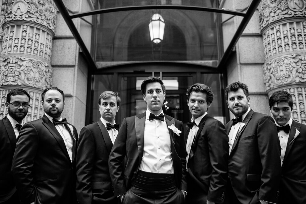 Groom and his groomsmen all stand next to each other and pose with serious faces outside the University Club in New York City.

University Club Wedding Photographer. Manhattan Luxury Wedding Photographer. Manhattan Bridal Portraits. Luxury Local Wedding NYC. 