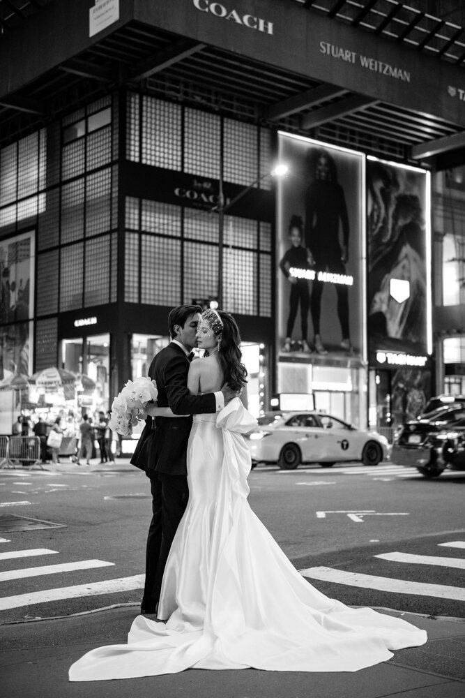 Bride and groom stand on a street corner in New York City embracing each other.

University Club Wedding Photographer. Manhattan Luxury Wedding Photographer. Manhattan Bridal Portraits. Luxury Local Wedding NYC. 