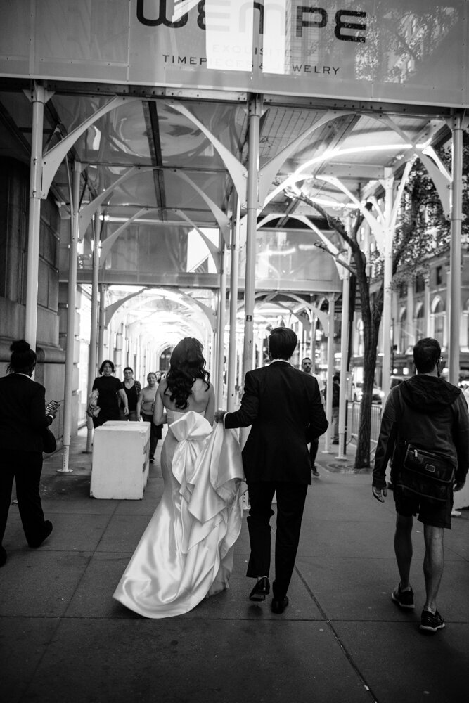 Bride and groom walk hand in hand down the New York City sidewalk. Photographed from behind.

University Club Wedding Photographer. Manhattan Luxury Wedding Photographer. Manhattan Bridal Portraits. Luxury Local Wedding NYC. 