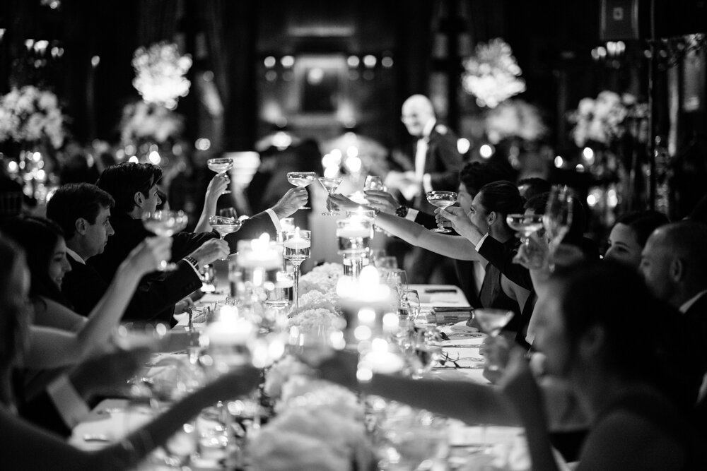 Glasses are lifted in cheers all along a table of wedding guests.

University Club Wedding Photographer. Manhattan Luxury Wedding Photographer. Manhattan Bridal Portraits. Luxury Local Wedding NYC. 