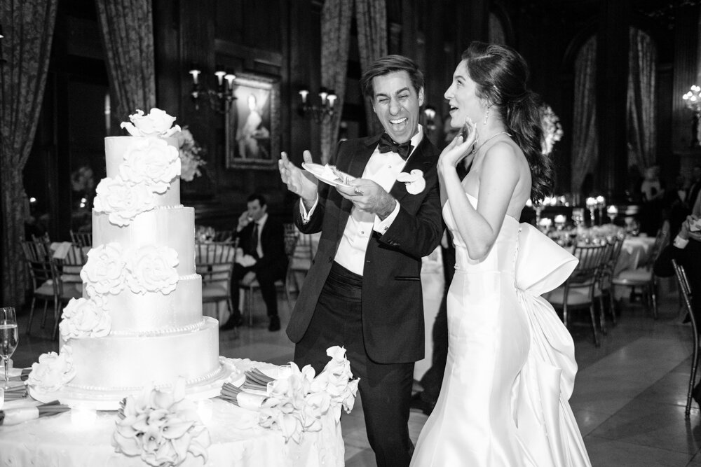 Bride and groom have excited expressions as they hold the first piece of cake.

University Club Wedding Photographer. Manhattan Luxury Wedding Photographer. Manhattan Bridal Portraits. Luxury Local Wedding NYC. 
