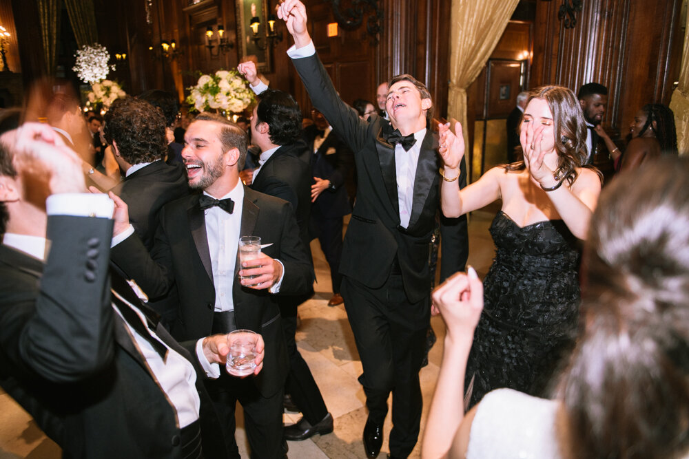 Wedding guests dance enthusiastically at the wedding reception at the University Club in New York City.

University Club Wedding Photographer. Manhattan Luxury Wedding Photographer. Manhattan Bridal Portraits. Luxury Local Wedding NYC. 