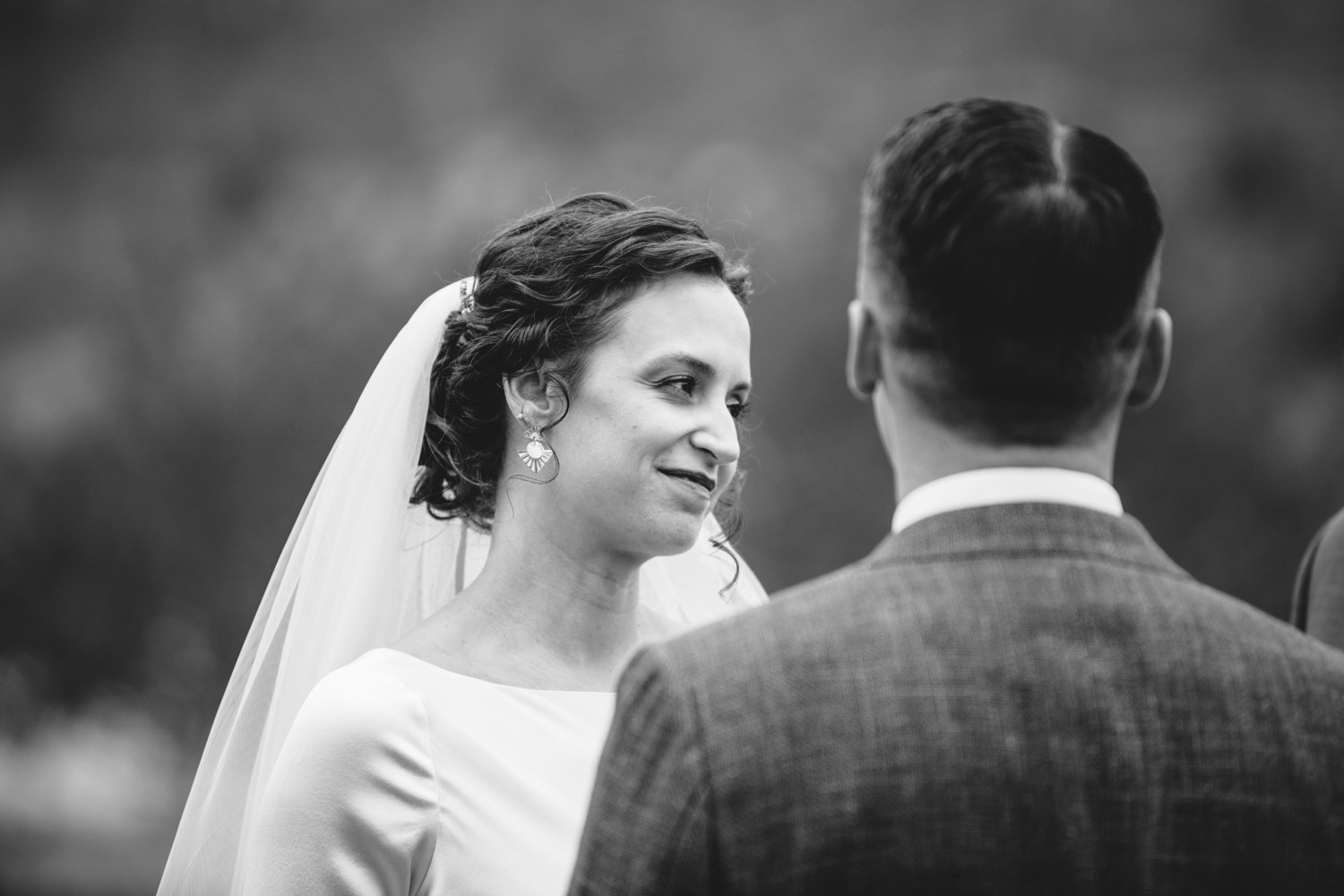 Bride stands in front of the groom and looks off to the side with a smile.

Upstate New York Wedding Photography. Cold Spring NY Wedding Photography. Luxury Local Wedding Photographer. Destination Wedding Photographer.