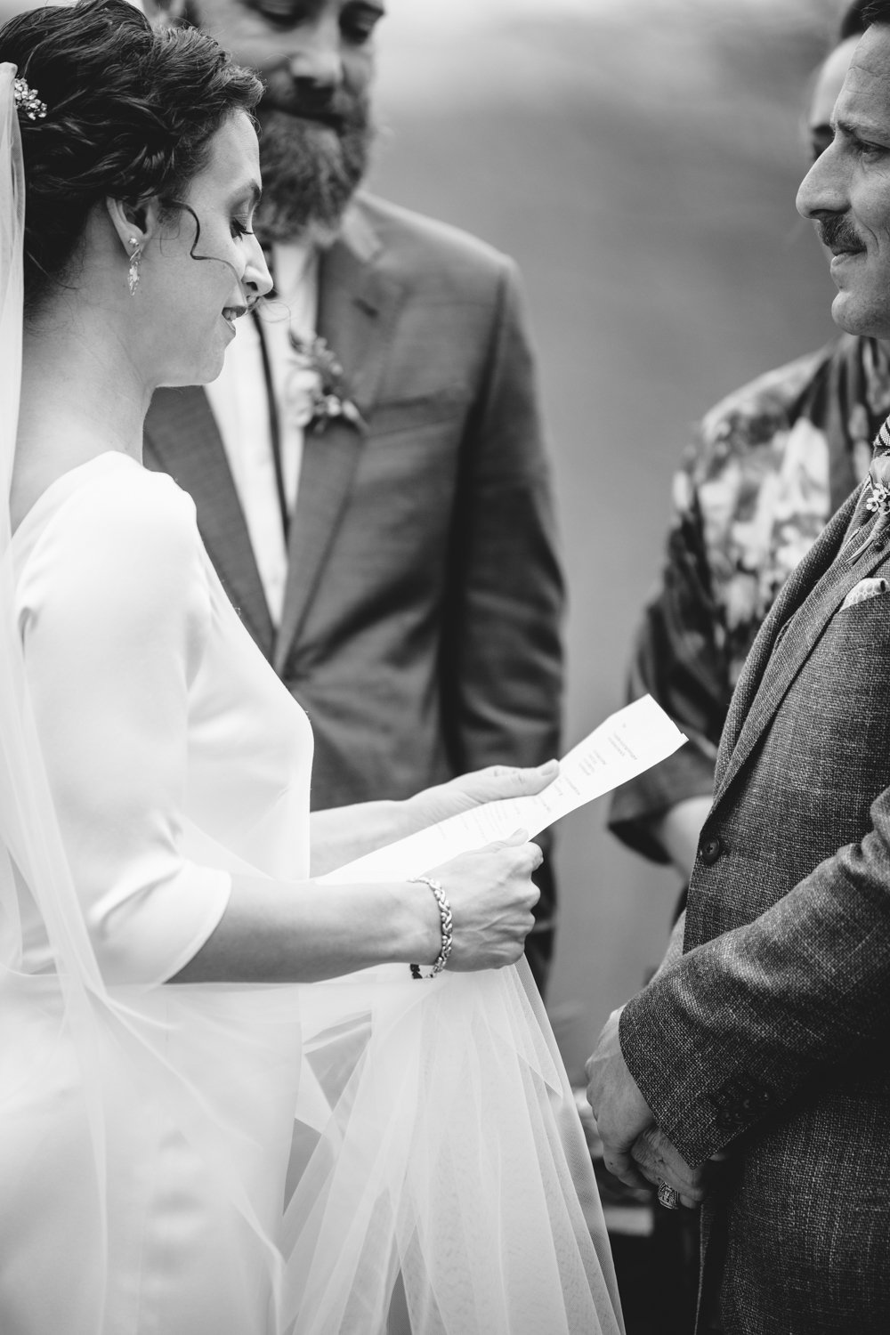 Bride reads from a paper as she stands facing the groom.

Upstate New York Wedding Photography. Cold Spring NY Wedding Photography. Luxury Local Wedding Photographer. Destination Wedding Photographer.