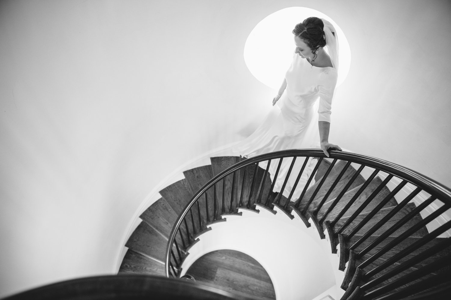 Bride photographed from above as she walks down a spiral staircase.

Upstate New York Wedding Photography. Cold Spring NY Wedding Photography. Luxury Local Wedding Photographer. Destination Wedding Photographer.