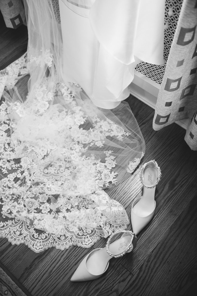 Close up of the lacy details of the bride's veil on the ground next to the bride's heels.

New York Wedding Photography. Long Island Wedding Photography. Luxury Local Wedding Photographer. Destination Wedding Photographer.