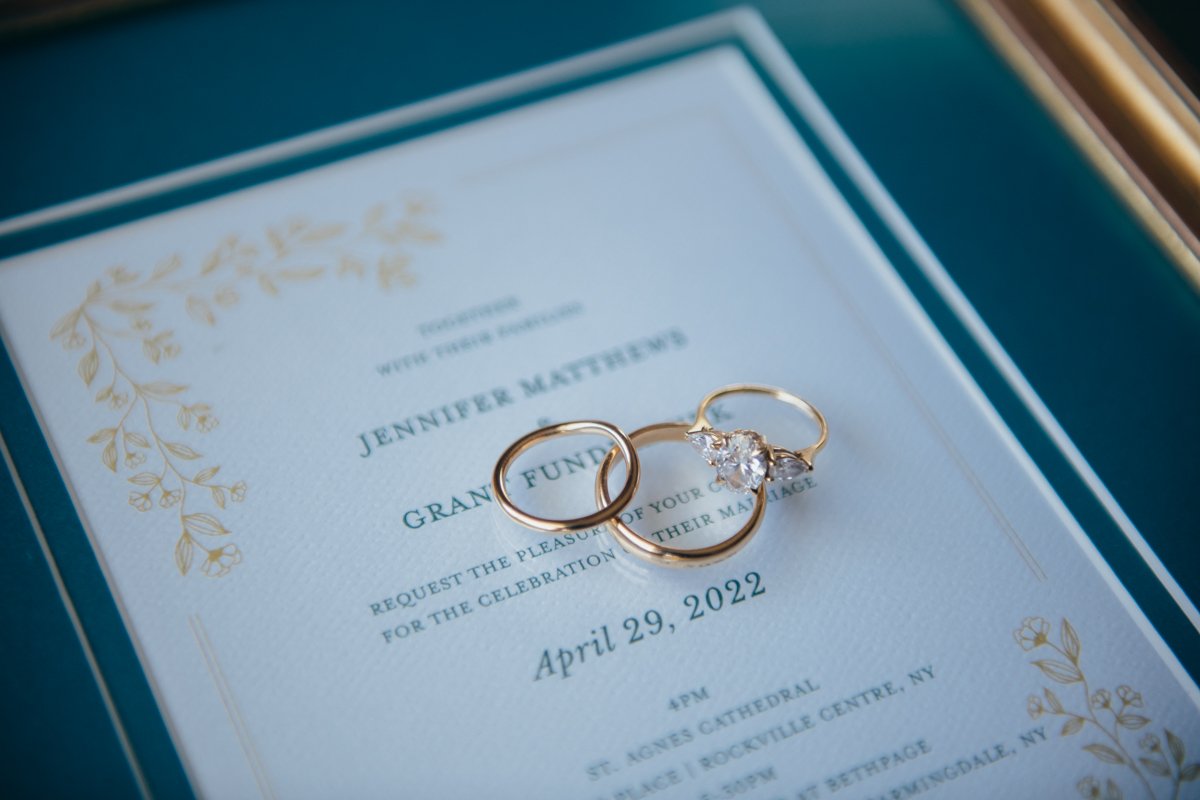 Detail shot of the wedding rings and engagement ring on a framed wedding invitation.

New York Wedding Photography. Long Island Wedding Photography. Luxury Local Wedding Photographer. Destination Wedding Photographer.