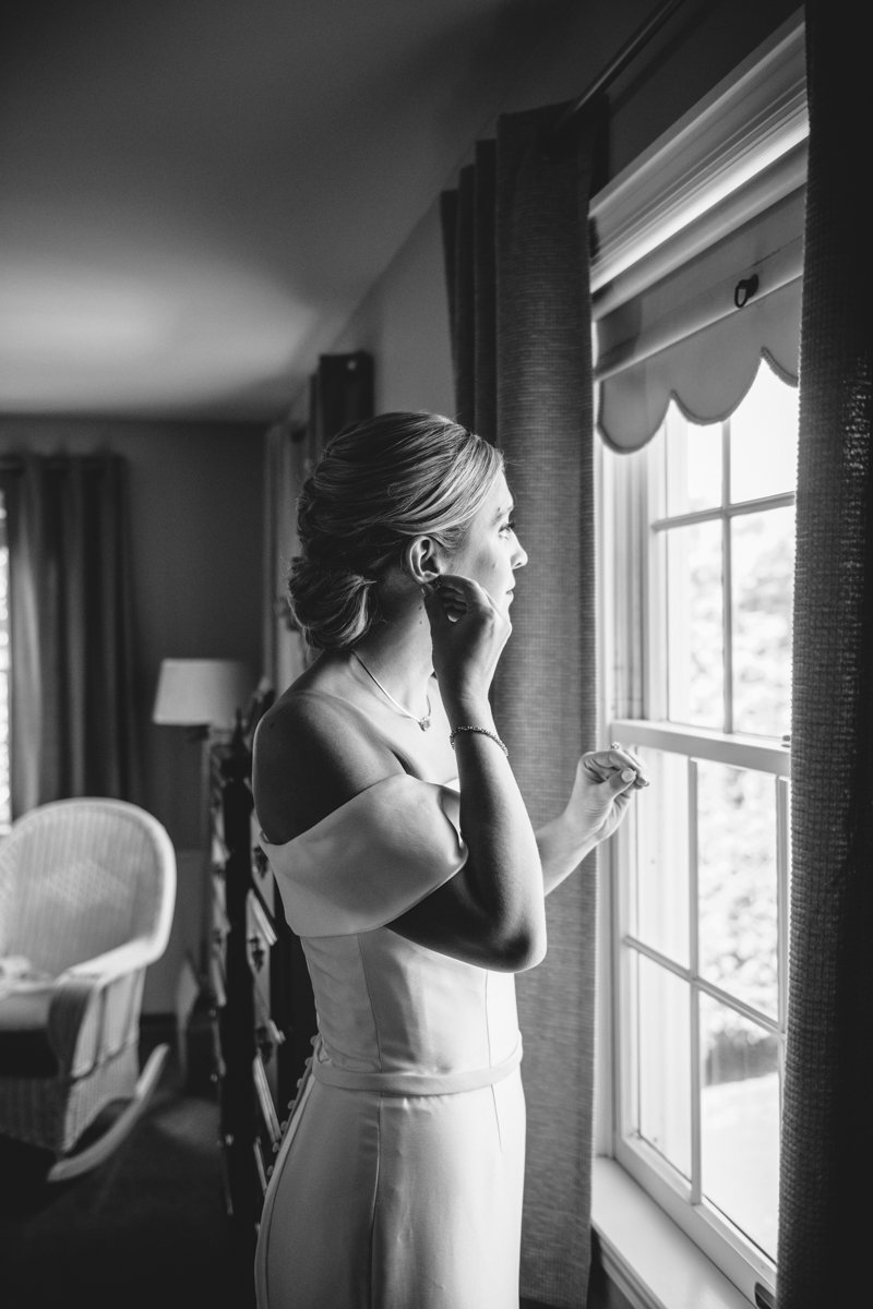 Bride looks out the window and reaches up to put in an earring.

New York Wedding Photography. Long Island Wedding Photography. Luxury Local Wedding Photographer. Destination Wedding Photographer.