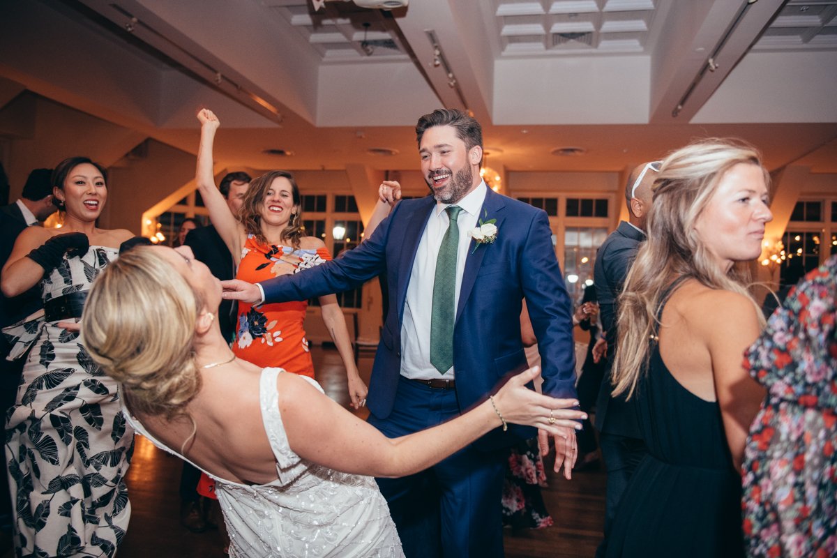 Bride and groom dance enthuastically with big smiles as wedding guests surround them.

New York Wedding Photography. Long Island Wedding Photography. Luxury Local Wedding Photographer. Destination Wedding Photographer.