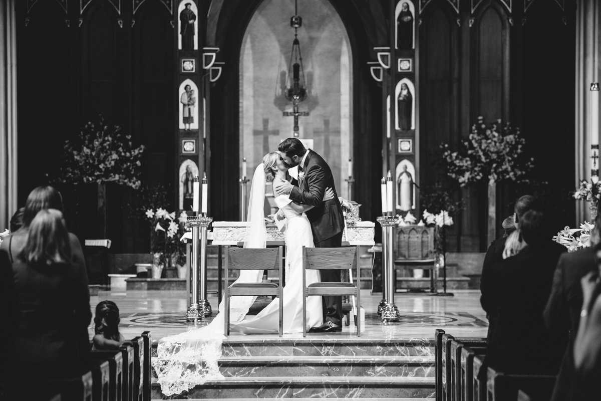 Bride and groom kiss at the altar.

New York Wedding Photography. Long Island Wedding Photography. Luxury Local Wedding Photographer. Destination Wedding Photographer.