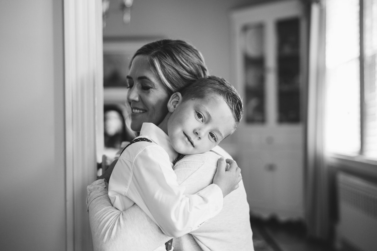 Young boy is in a woman's arms and they are both smiling, she with her eyes closed, and he looking at the camera.

New York Wedding Photography. Long Island Wedding Photography. Luxury Local Wedding Photographer. Destination Wedding Photographer.