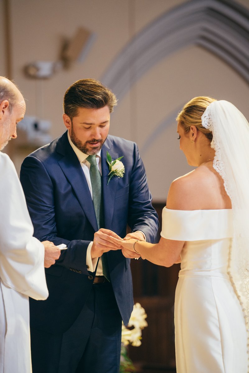 Groom puts a wedding ring on the bride's finger.

New York Wedding Photography. Long Island Wedding Photography. Luxury Local Wedding Photographer. Destination Wedding Photographer.